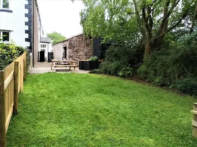 a backyard with a picnic table and a tree at 3 Bed in Ennerdale Bridge SZ392 in Ennerdale Bridge