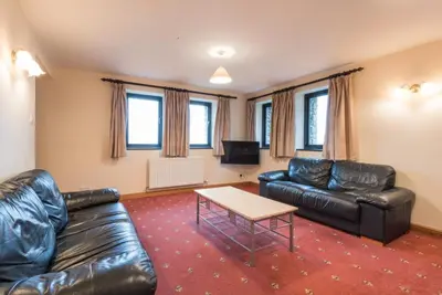 a living room with a leather couch and a table at 3 Bed in Threlkeld SZ433 in Threlkeld