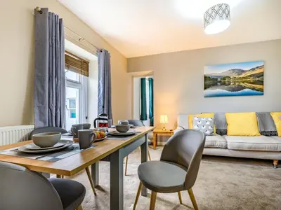 a living room with a table and chairs and a couch at 2 Bed in Cockermouth oc-87481 in Cockermouth