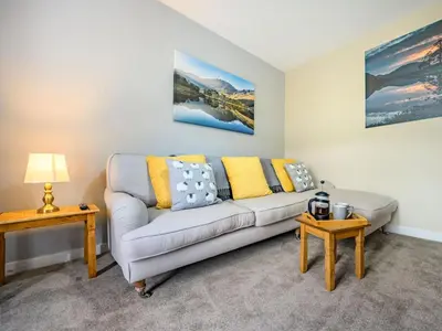 a living room with a couch and two tables at 2 Bed in Cockermouth oc-87481 in Cockermouth