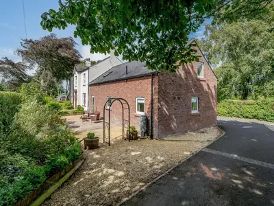 a brick building with a gate next to a street at 1 Bed in Grinsdale Bridge 85163 in Carlisle