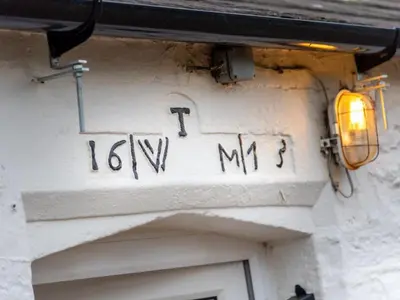 a sign on the side of a building with a light at 2 Bed in Mawbray SZ214 in Mawbray