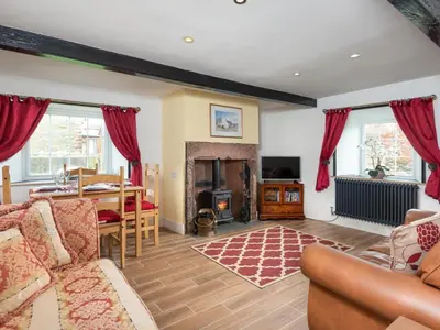 a living room with a couch and a table and a fireplace at 2 Bed in Mawbray SZ214 in Mawbray