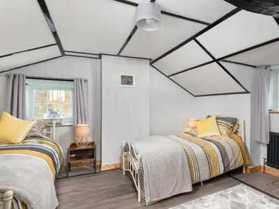 a bedroom with two beds and a ceiling with skylights at 2 Bed in Mawbray SZ214 in Mawbray