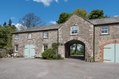 a large brick building with an archway at 2 Bed in Boltongate SZ396 in Mealsgate