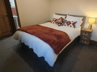 a bedroom with a large bed with pillows at The Herdwick Inn in Penruddock