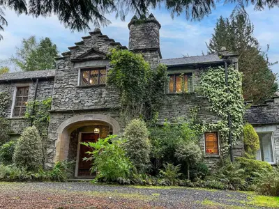 an old stone house with a chimney at Daweswood, Patterdale, characterful with fairy tale garden and fell walks from the door in Patterdale