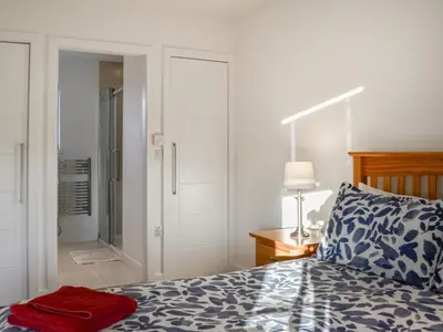 a bedroom with a bed with a red towel on it at The Longhouse At Threave in Castle Douglas