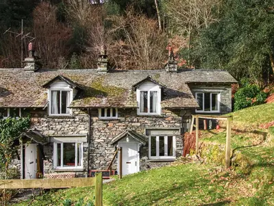 an old stone house on the side of a hill at Tarn Cottage in Grasmere