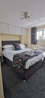 a bedroom with two beds and a ceiling at The Wee Hoose in Dumfries