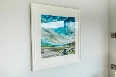 a picture of a painting on a wall at High Tide Lodge in Gatehouse of Fleet