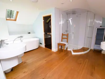 a bathroom with a tub and a sink and a shower at 4 Bed in Moffat 82374 in Moffat