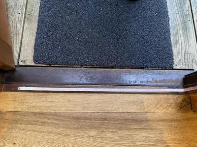 a black rug sitting on top of a wooden floor at Buzzard Lodge with Hot-tub in Carlisle