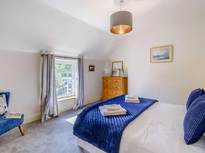 a bedroom with a bed and a window at 2 Bed in Glenridding 85425 in Glenridding