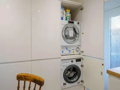 a washer and dryer in a room with a chair at 2 Bed in Glenridding 85425 in Glenridding