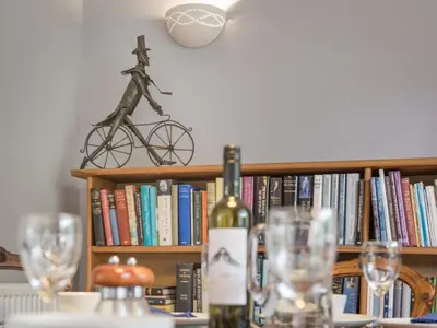 a bottle of wine sitting on a table with glasses at 3 Bed in Portinscale SZ528 in Portinscale