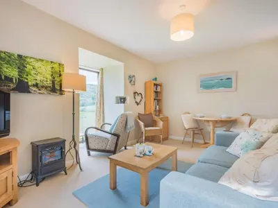 a living room with a blue couch and a fireplace at 1 Bed in Matterdale SZ222 in Watermillock