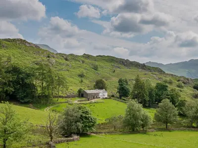 an old house on a hill in a green field at 3 Bed in Seathwaite SZ107 in Eskdale