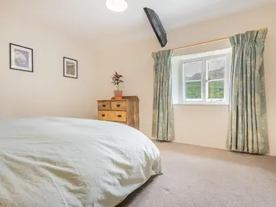 a bedroom with a bed and a window at 3 Bed in Seathwaite SZ107 in Eskdale