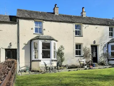 a large white house with a lawn in front of it at 1 bed property in Keswick 86117 in Braithwaite