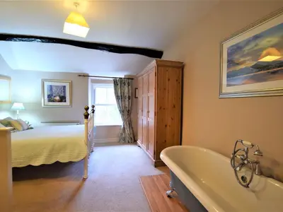 a bathroom with a bed and a bath tub in a room at 1 bed property in Keswick 86117 in Braithwaite