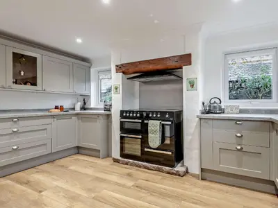 a kitchen with white cabinets and a black oven at 2 Bed in Rosthwaite 86397 in Rosthwaite