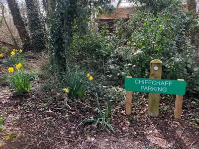 a sign for a butterfly gate parking in a garden at Chiffchaff Lodge with Hot tub in Carlisle