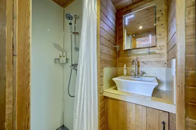 a bathroom with a sink and a shower at Egret Lodge with Hot-tub in Carlisle