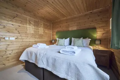 a bedroom with a bed with towels on it at Gadwall Lodge with Hot-tub in Carlisle
