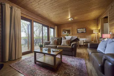 a living room with a couch and a table at Heron Lodge with Hot-tub in Carlisle