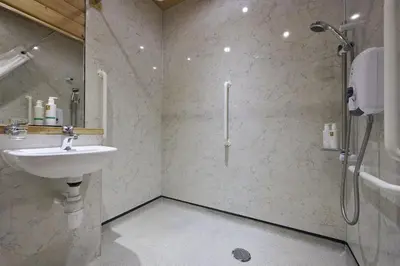 a bathroom with a sink and a shower at Heron Lodge with Hot-tub in Carlisle