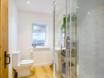 a bathroom with a toilet and a glass shower at 3 Bed in Lockerbie 89406 in Lockerbie