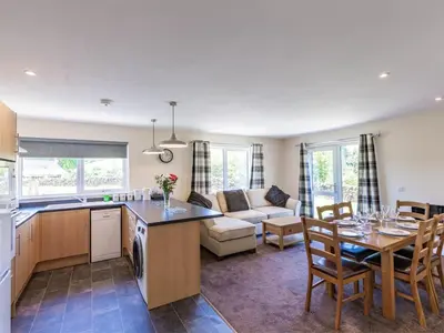 a kitchen and living room with a table and a dining room at 3 Bed in Moffat oc-ca402 in Moffat