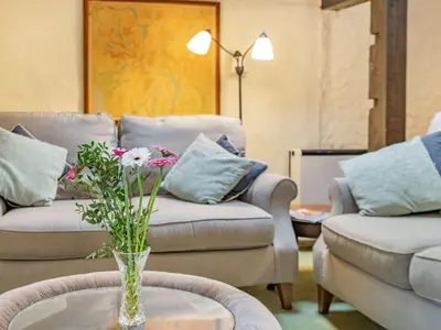 a living room with couches and a vase with flowers on a table at 2 Bed in Wasdale Head SZ053 in Nether Wasdale
