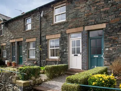 a brick house with a blue door and windows at 2 Bed in Keswick oc-sz009 in Keswick
