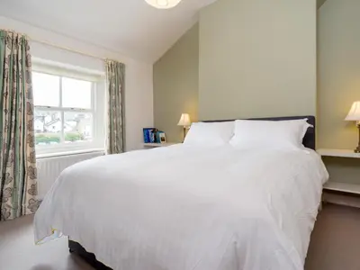 a white bed in a bedroom with a window at 2 Bed in Keswick oc-sz009 in Keswick