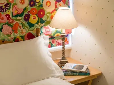 a lamp sitting on a table next to a bed at 2 Bed in Keswick oc-sz009 in Keswick