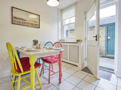 a dining room with a table and colorful chairs at 2 Bed in Keswick oc-sz009 in Keswick