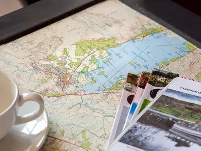 a map and a cup of coffee on a table at 2 Bed in Keswick oc-sz009 in Keswick