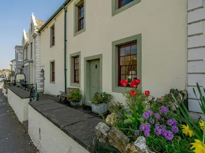 a house with flowers on the side of the street at 2 Bed in Keswick 80515 in Keswick