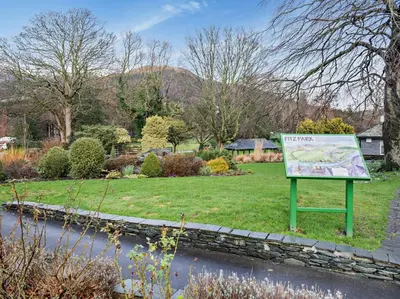 a sign in the middle of a garden with a pond at 2 Bed in Keswick 80515 in Keswick