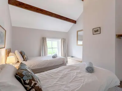 a bedroom with two beds and a window at 8 bed in Cockermouth 82453 in Bridekirk