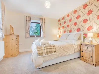 a bedroom with a large bed and a window at 3 Bed in Threlkeld SZ217 in Threlkeld