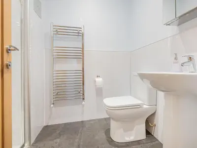 a white bathroom with a toilet and a sink at 3 Bed in Threlkeld SZ217 in Threlkeld