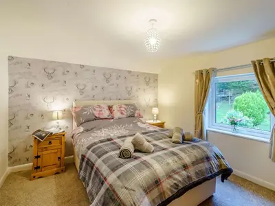 a bedroom with a bed and a window at 3 Bed in Threlkeld 86613 in Threlkeld