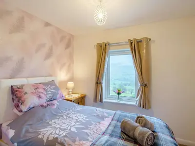 a bedroom with a bed and a window at 3 Bed in Threlkeld 86613 in Threlkeld