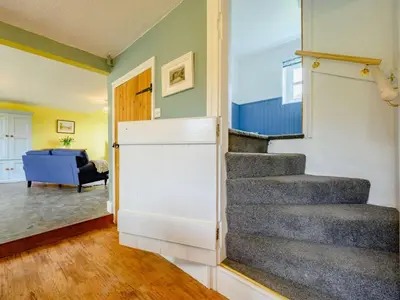 a staircase in a living room with a blue couch at 2 Bed in Egremont 87227 in Egremont