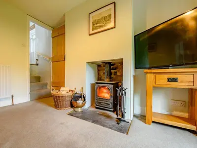 a living room with a fireplace and a television at 2 Bed in Egremont 87227 in Egremont