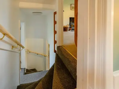 a hallway with stairs leading up to a house at 2 Bed in Egremont 87227 in Egremont