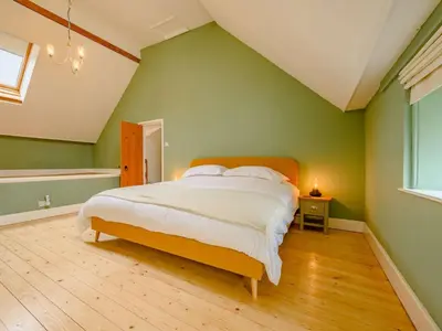 a bedroom with a large bed with green walls at 2 Bed in Egremont 87227 in Egremont
